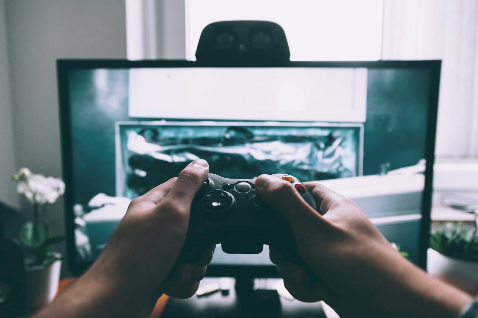 A player holding a controller in front of a monitor, the moment a Metacritic score stops mattering